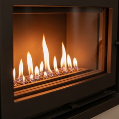 Close up of bright gas flames inside a modern fireplace. Gas heating in home living room interiors. Natural energy source.