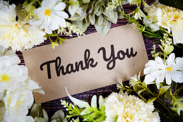 Thank You text with flowers bouquet decoration on wooden background