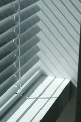 blinds on the window close-up, lines of light and shadow	