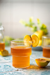 Healthy organic food. Apple cider or vinegar in a glass and fresh apples on a light background.