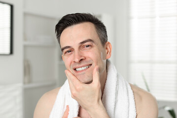 Portrait of smiling man after shaving at home