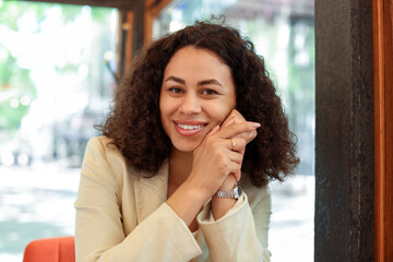 Portrait of smiling Latin American woman in cafe