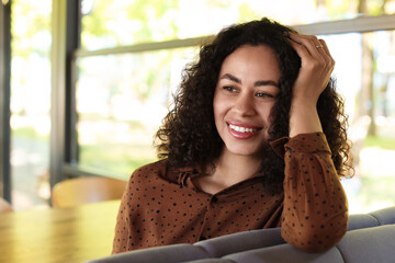 Portrait of smiling Latin American woman in cafe