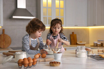 Cooking recipe. Cute children making dough for cookies at table in kitchen