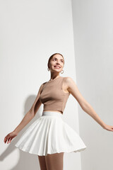 Naklejka premium beautiful girl in a summer billowing tennis skirt