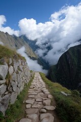 Scenic mountain pathway with stone wall and lush greenery in dense clouds