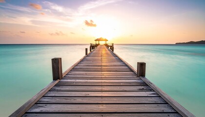 Obraz premium muelle de madera que se extiende directamente hacia el horizonte, sumergiéndose en un mar de un llamativo color turquesa.