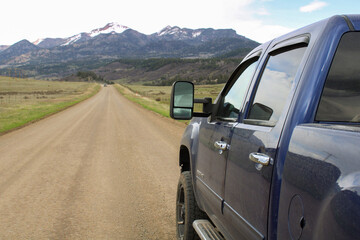 Rugged Colorado: Blue Truck on Dirt Road, Scenic Mountains © Eric Heroux
