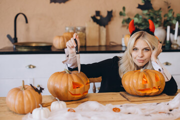 Woman Carving Halloween Pumpkins at Home