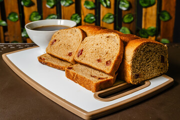 horizontal photo of traditional whole wheat artisan sliced bread with guava jam next to a cup of coffee in a healthy vegetarian restaurant in Colombia