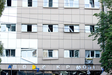 Damaged apartment building with broken windows