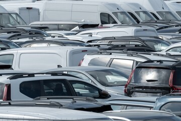 Parked cars filling a large parking lot during the day