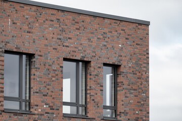 Modern brick wall with windows showing contemporary architectural design
