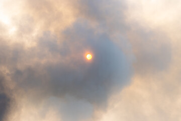 Sun partially hidden behind thick smoke