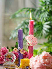 Beautiful pink and purple handmade beeswax candles. Candles for Love, femininity and sexuality.  Aromatherapy. Wax candles. Selective focus