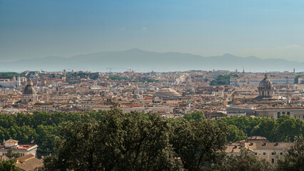 Obraz premium Panoramic view over Rome’s rooftops with landmarks like the Pantheon, Piazza Navona, and Villa Borghese visible on a sunny day, ideal for travel and cityscape concepts.
