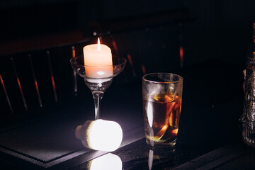 Power outage. Romance. A candle and a battery-powered lamp are on the table.