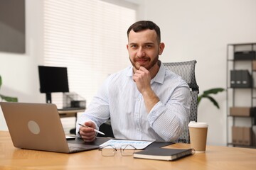 Handsome man working at desk in office