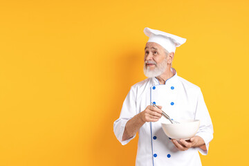 Professional pastry chef with whisk and bowl on orange background, space for text
