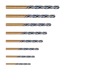 Set of eight pieces of bronze metal drill bits, gold-colored spiral cutting side edges, dark...