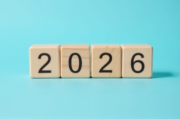 A wooden block with the year 2020 engraved, useful for decorative or organizational purposes..New Year 2026.