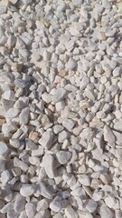white river grit stones background. Marbled white gravel. Crushed stone texture. White background of small stones