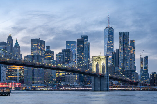 Lower Manhattan skyline with Brooklyn Bridge at dusk, New York City, USA