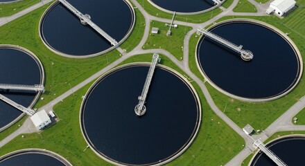 Aerial View of Circular Water Treatment Plant Tanks and Green Grass