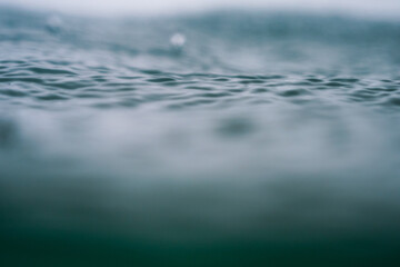 Obraz premium Rain in the sea, raindrops being photographed with a shallow depth of field in the Atlantic Ocean