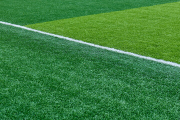 Obraz premium Close up of bright green artificial turf and crisp white markings