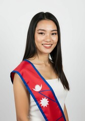 Smiling Nepalese Woman with National Flag Sash Against a Clean White Backdrop