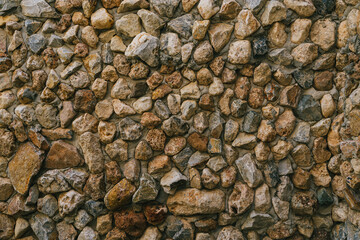 Stone background. Textured Background of Varied Natural Stones in Earthy Tones with Diverse Shapes...