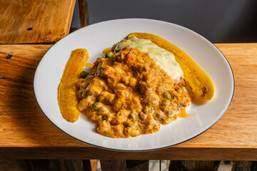 Horizontal photo of vegetarian lasagna with slices of ripe banana in a healthy vegetarian restaurant in Colombia.