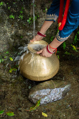 Traditional Indian Woman Collecting Spring Water in a Brass Pot