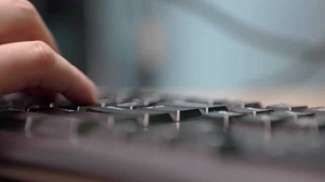Typing at computer keyboard in home office 4k
