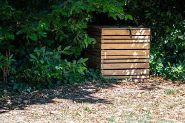 Wooden Compost Bin in a Green Garden Corner