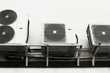 Outdoor air conditioning units on white wall. Industrial cooling equipment installation....