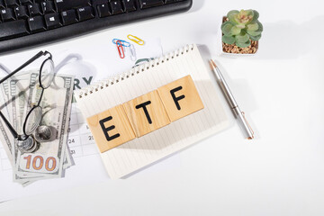 ETF Wooden Block with Cash on Desk – Investment Concept, Top View