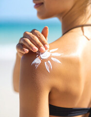 A close-up of sunscreen being applied to a translucent glass surface with soft white strokes.