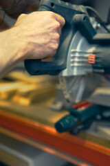 Mountain craftsman using a circular saw in a workshop nestled in the Alps during the early morning light