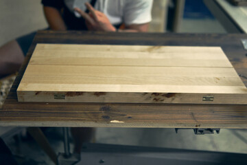 Wooden craftsmanship featuring a polished board on a sturdy table in the Alpine region