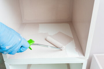 Hand Painting Shelf Interior With Small Roller