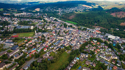 Fototapeta premium Aerial view around the old town in the city Naila on an cloudy spring day in Germany