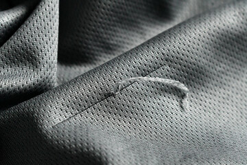 Pulled satin fabric. A snag on clothes textile.