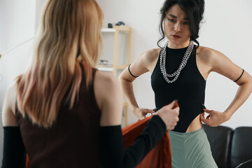 young adult woman working with colleague, socializing at workplace, business environment with Gen Z...