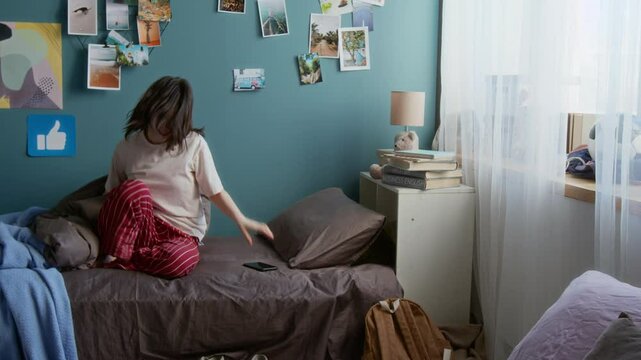 Side view shot of Caucasian teen girl waking up late for school in college dorm room packing backpack for classes