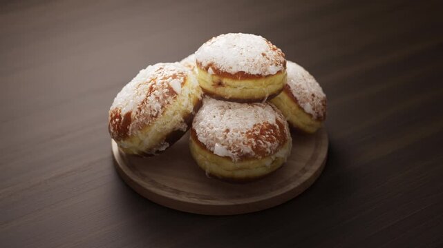 Looping animation around a composition of European classic donuts lying on a wooden board. Loop motion. Defocus. Close-up.