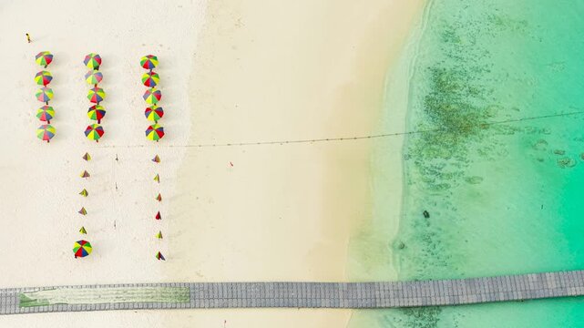 Sea coast and umbrellas on the shore. Beach umbrellas on the island of Racha, a view from a great height on the rest on the coast.