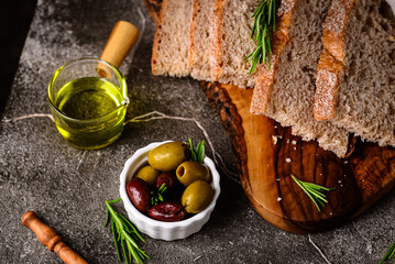 Fresh bread, olive oil and mix of olives.