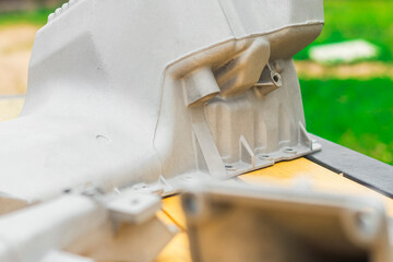 Metal engine component displayed against a textured gray background highlighting its design and...
